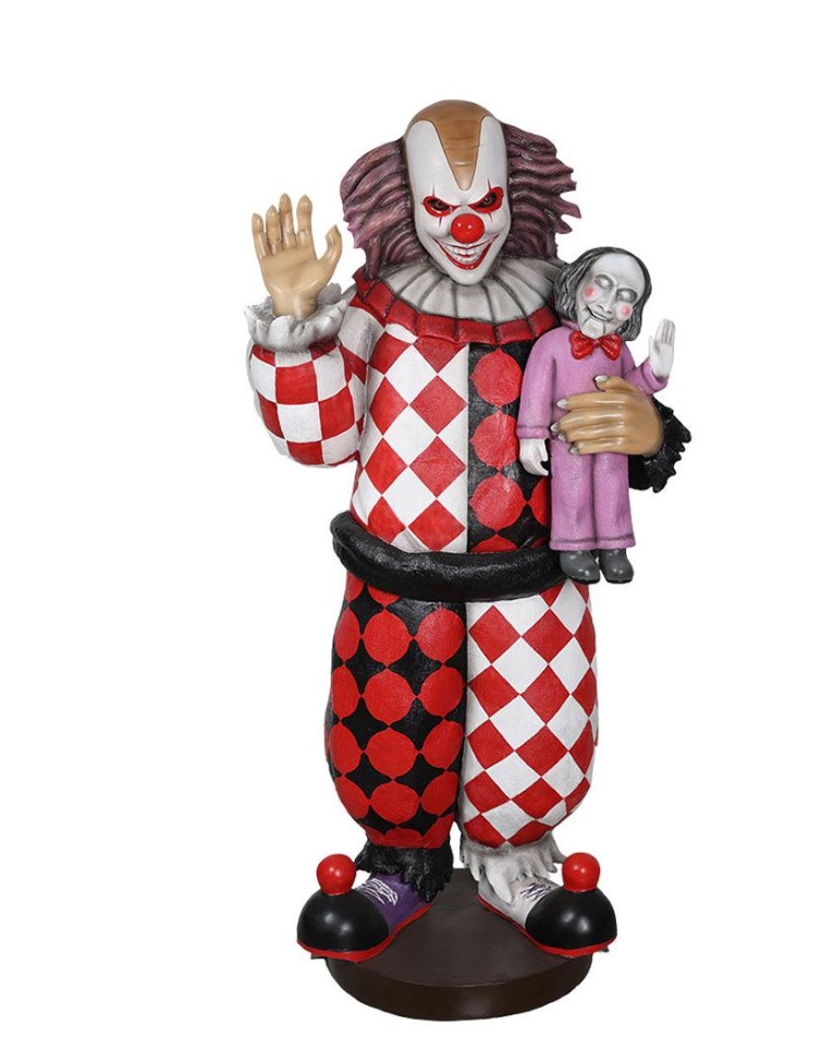 Creepy Halloween Jester Clown lifting his hand as if to wave, while holding a doll.