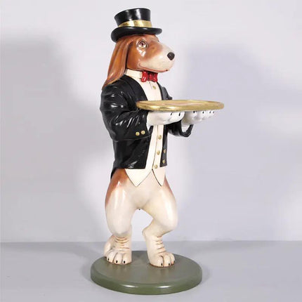 Dog statue in a formal outfit with a top hat and tray on a plain background