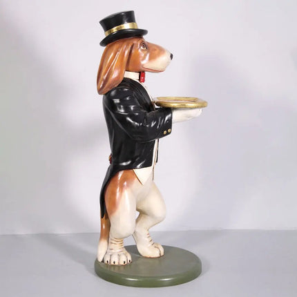 Dog figurine in a suit and top hat holding a tray on a white background