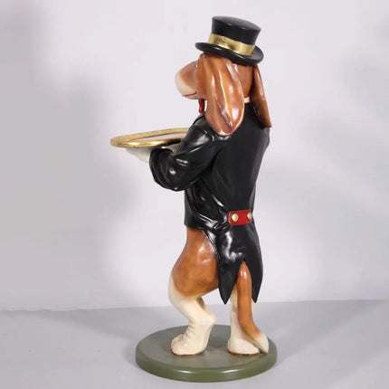Dog figurine in a top hat and coat holding a tray on a gray background