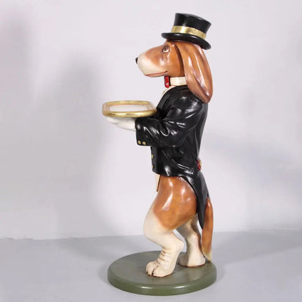 Dog figurine in a suit and top hat holding a tray on a white background