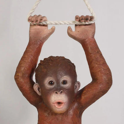 Stylized image of a monkey holding onto a rope against a plain background