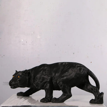 Black panther statue on a white pedestal against a light gray background
