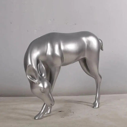 Metallic silver deer sculpture on a neutral background