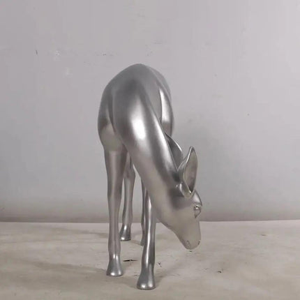 Metallic silver deer sculpture on a neutral background