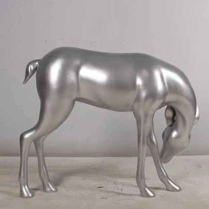 Metallic silver deer sculpture on a neutral background