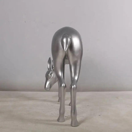 Metallic silver deer sculpture on a neutral background