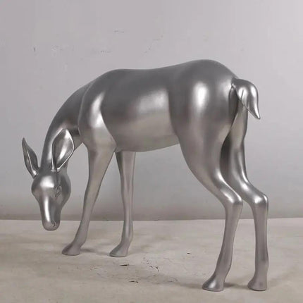 Metallic silver deer sculpture on a neutral background