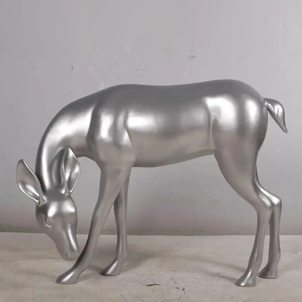 Metallic silver deer sculpture on a neutral background