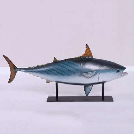 Model of a bluefin tuna on a stand against a light gray background