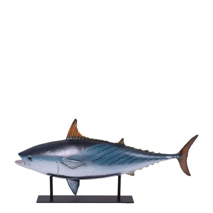 Model of a bluefin tuna on a stand against a white background