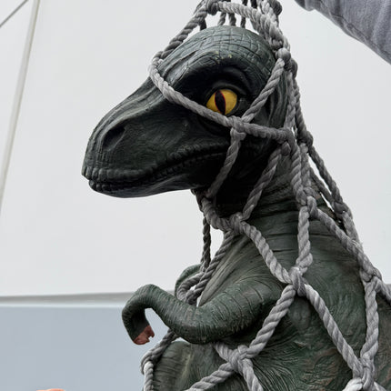 Baby T-Rex Dinosaur In Net Life Size Statue